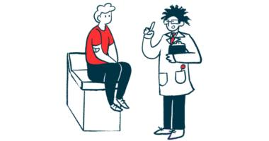 A doctor speaks with a person sitting on an examination table.