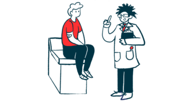 A doctor speaks with a person sitting on an examination table.