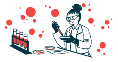 A scientist in a lab uses a petri dish and dropper to test blood, alongside a rack with four filled vials.