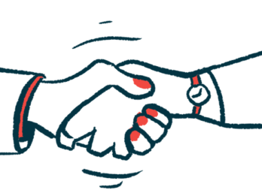 Two people's hands are seen clapsed in a handshake.